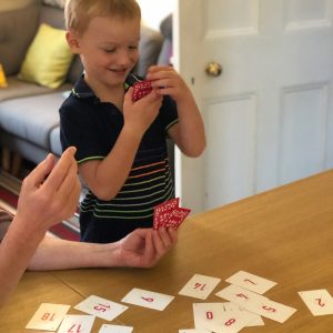 Young boy with cards at home